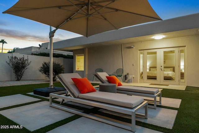 patio terrace at dusk with an outdoor hangout area and french doors