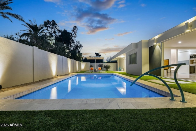 view of pool at dusk