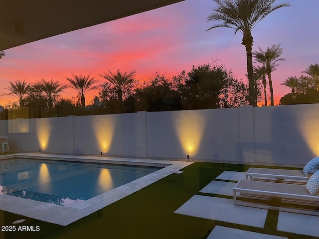 view of pool at dusk