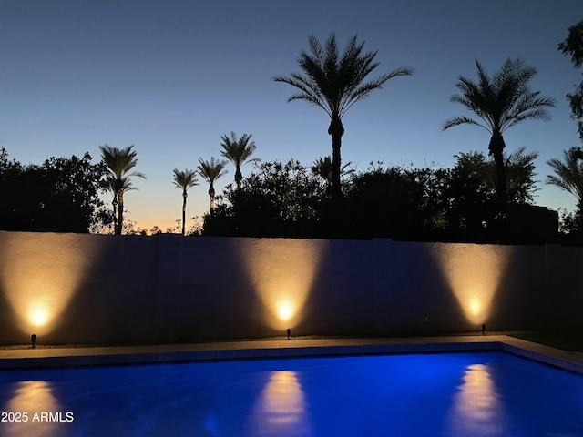 view of pool at dusk