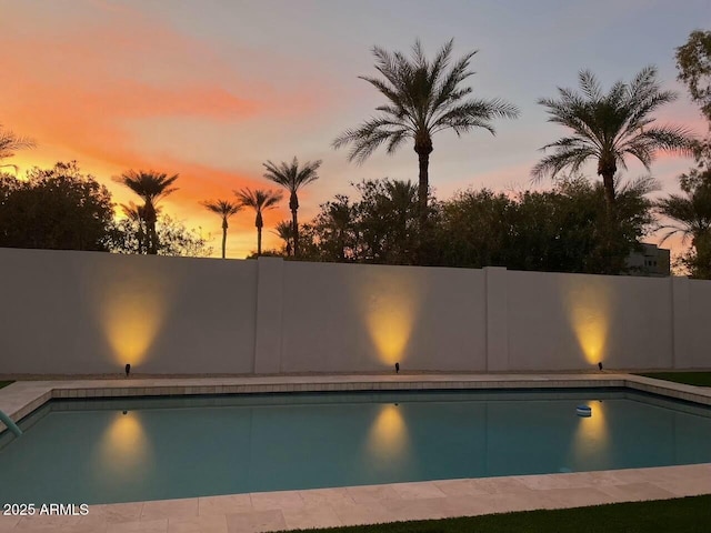 view of pool at dusk