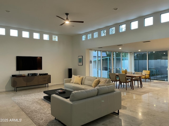 living room featuring ceiling fan and plenty of natural light