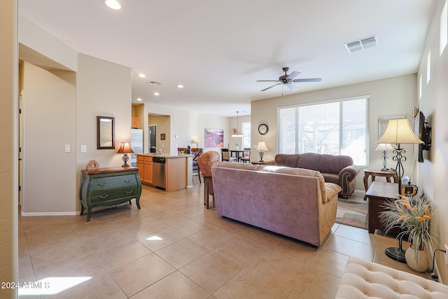 tiled living room with ceiling fan