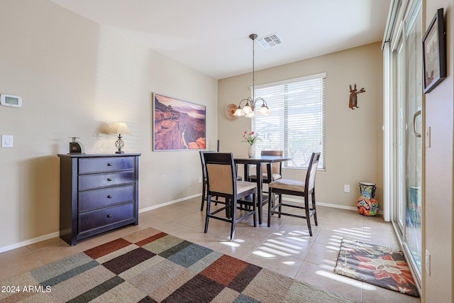 dining room featuring a chandelier and light tile patterned flooring