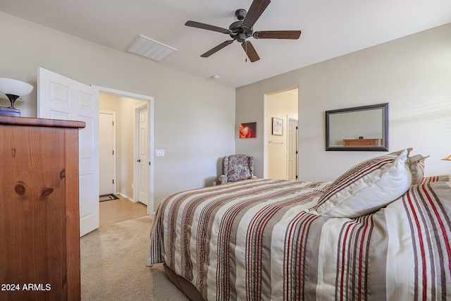 bedroom with light colored carpet and ceiling fan