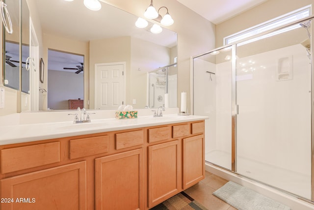 bathroom with tile patterned flooring, vanity, and a shower with door