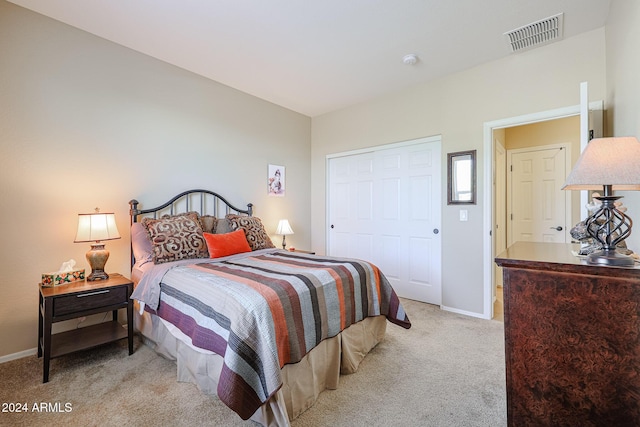 carpeted bedroom featuring a closet