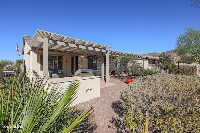 rear view of property featuring an outdoor living space, a pergola, and a patio