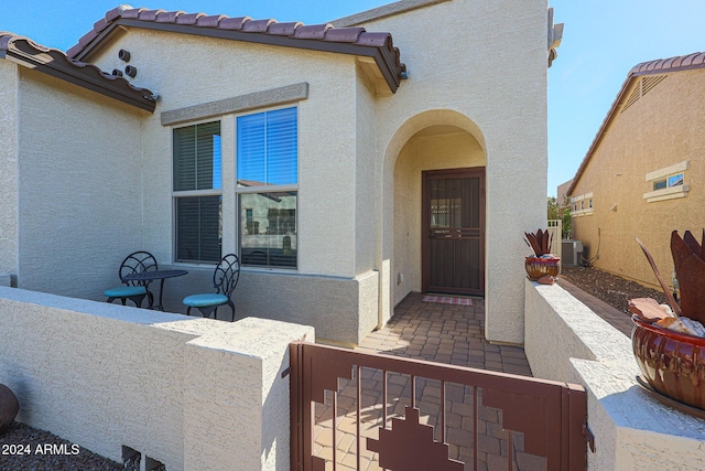 view of exterior entry with central AC unit