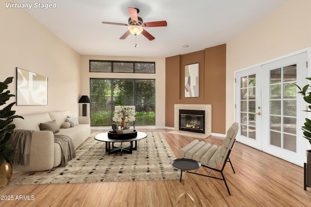 4135 E Altadena Ave, Phoenix, AZ 85028 - living room with wood finished floors, a glass covered fireplace, a ceiling fan, and french doors