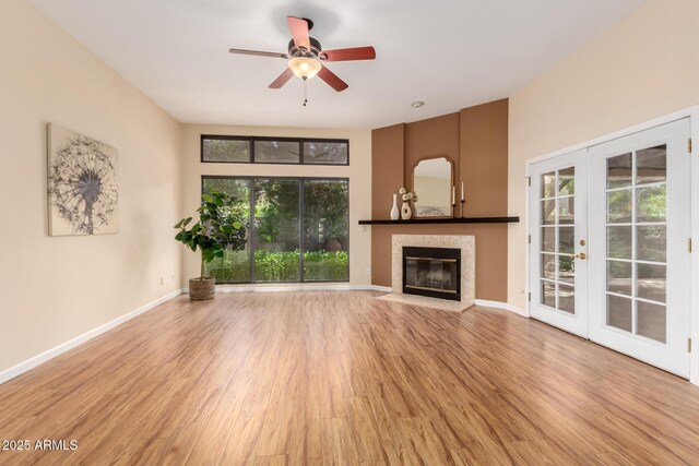 4135 E Altadena Ave, Phoenix, AZ 85028 - unfurnished living room featuring french doors, wood finished floors, a glass covered fireplace, and ceiling fan