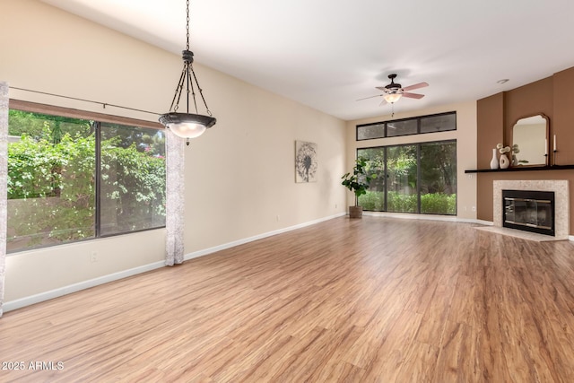 4135 E Altadena Ave, Phoenix, AZ 85028 - unfurnished living room featuring a ceiling fan, a fireplace with flush hearth, and wood finished floors