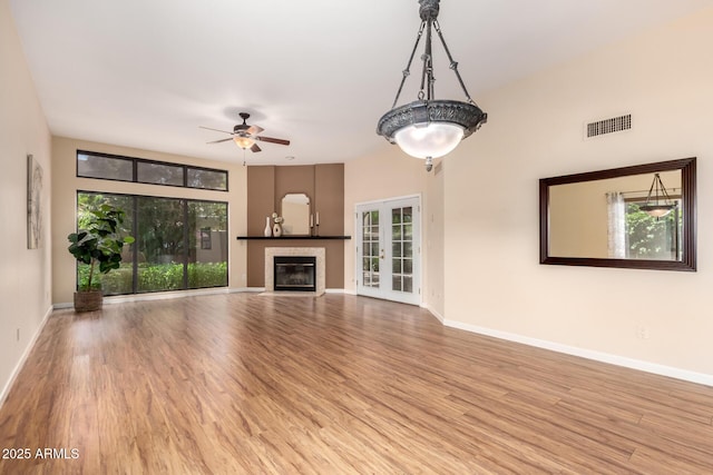 4135 E Altadena Ave, Phoenix, AZ 85028 - unfurnished living room with a glass covered fireplace, wood finished floors, and ceiling fan