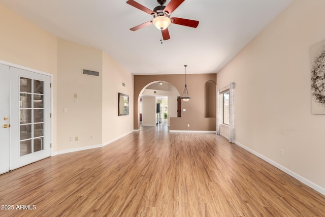 4135 E Altadena Ave, Phoenix, AZ 85028 - unfurnished living room with arched walkways, ceiling fan, and light wood finished floors
