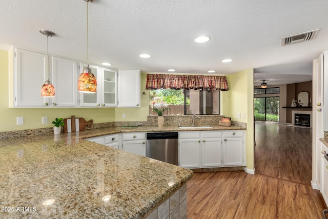 4135 E Altadena Ave, Phoenix, AZ 85028 - kitchen with stainless steel dishwasher, white cabinetry, wood finished floors, pendant lighting, and a ceiling fan