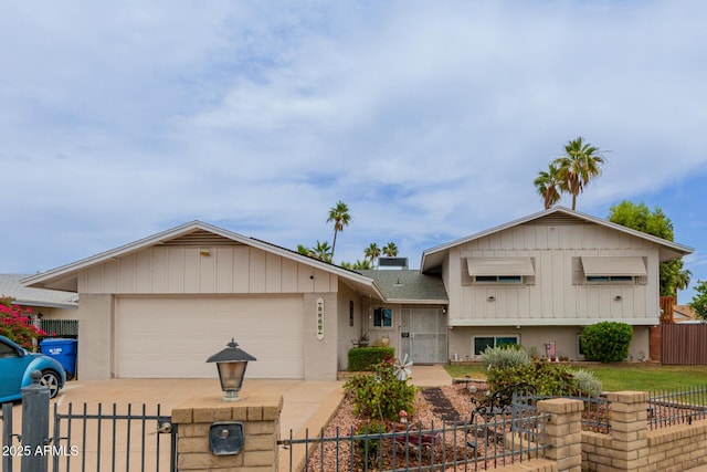 14001 N 34th Dr, Phoenix, AZ 85053 - split level home featuring a fenced front yard, concrete driveway, a garage, and a gate