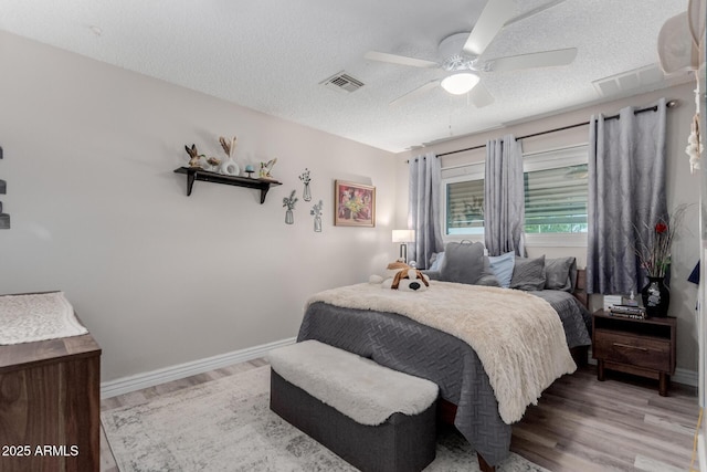 14001 N 34th Dr, Phoenix, AZ 85053 - bedroom with a textured ceiling, wood finished floors, ceiling fan, and baseboards