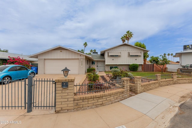14001 N 34th Dr, Phoenix, AZ 85053 - tri-level home featuring a fenced front yard, concrete driveway, a garage, and a gate