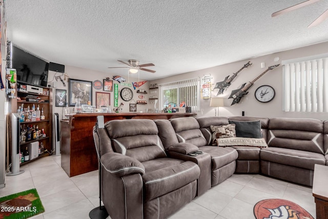 14001 N 34th Dr, Phoenix, AZ 85053 - living area featuring ceiling fan, a dry bar, light tile patterned flooring, and a textured ceiling