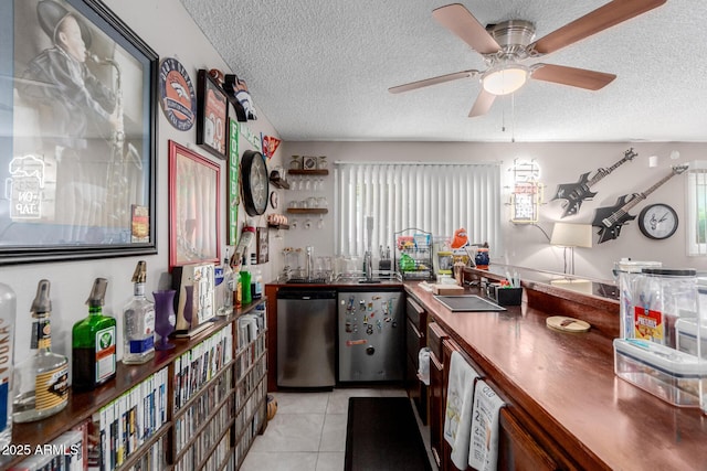 14001 N 34th Dr, Phoenix, AZ 85053 - kitchen with stainless steel dishwasher, a textured ceiling, light tile patterned flooring, dark countertops, and ceiling fan