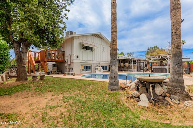 14001 N 34th Dr, Phoenix, AZ 85053 - rear view of house with a wooden deck, board and batten siding, stairs, and a chimney