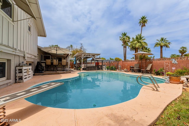 14001 N 34th Dr, Phoenix, AZ 85053 - view of swimming pool featuring a patio, a fenced backyard, and a diving board