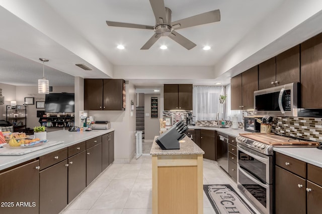 14001 N 34th Dr, Phoenix, AZ 85053 - kitchen featuring stainless steel appliances, a ceiling fan, light countertops, and dark brown cabinets