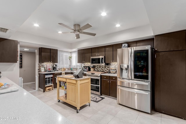 14001 N 34th Dr, Phoenix, AZ 85053 - kitchen featuring appliances with stainless steel finishes, light countertops, dark brown cabinetry, ceiling fan, and recessed lighting