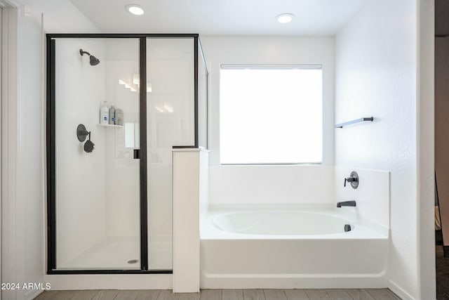 bathroom featuring separate shower and tub and plenty of natural light