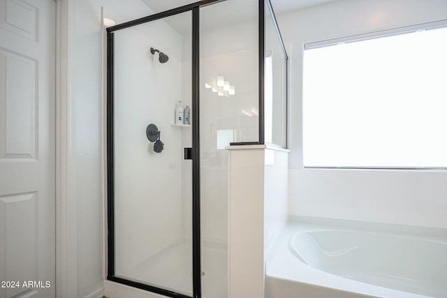 bathroom with separate shower and tub