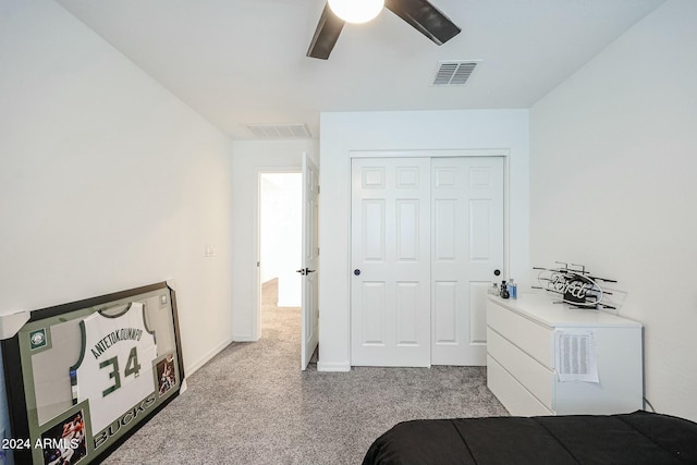 carpeted bedroom featuring a closet and ceiling fan