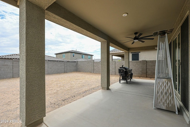 view of patio with area for grilling and ceiling fan