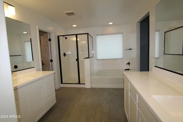 bathroom with vanity, shower with separate bathtub, and hardwood / wood-style flooring