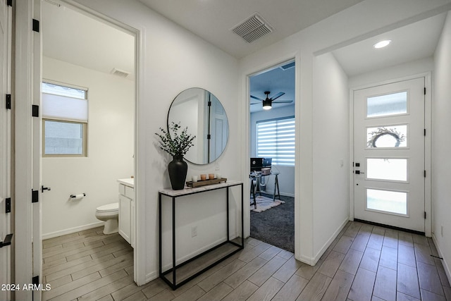 foyer with light wood-type flooring and ceiling fan