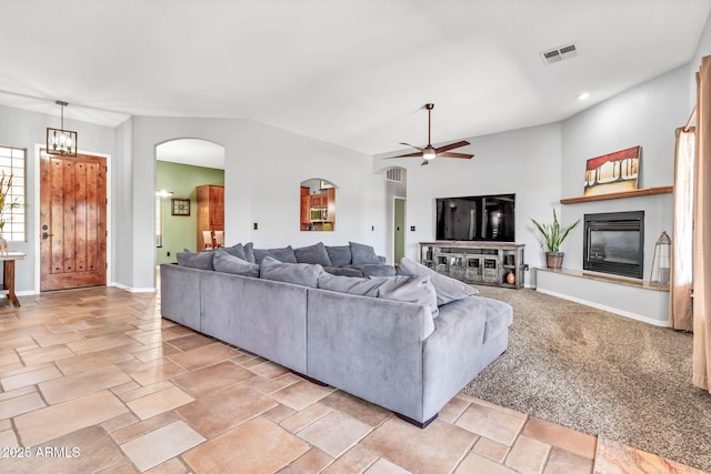 2699 E Claxton Rd, Gilbert, AZ 85297 - living room featuring a glass covered fireplace, arched walkways, ceiling fan, and recessed lighting