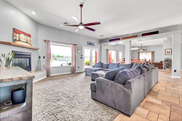 2699 E Claxton Rd, Gilbert, AZ 85297 - living room with a glass covered fireplace, ceiling fan, recessed lighting, and light stone finish floors