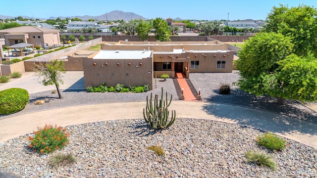 2699 E Claxton Rd, Gilbert, AZ 85297 - pueblo-style home with a residential view, stucco siding, and a mountain view