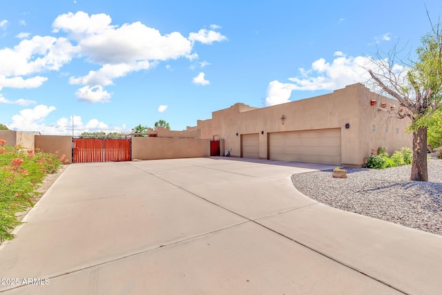 2699 E Claxton Rd, Gilbert, AZ 85297 - view of side of property featuring stucco siding, a garage, a gate, and concrete driveway
