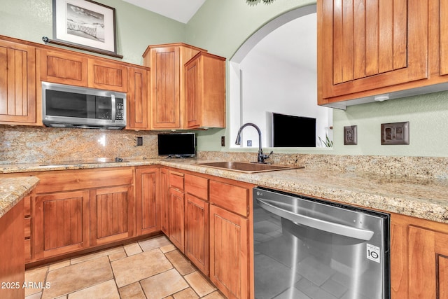 2699 E Claxton Rd, Gilbert, AZ 85297 - kitchen featuring appliances with stainless steel finishes, tasteful backsplash, arched walkways, and light stone countertops