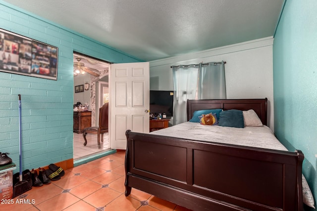 bedroom featuring a textured ceiling and light tile patterned floors