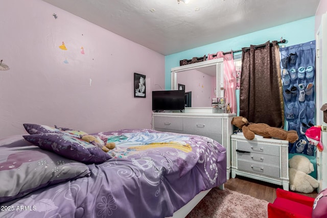 bedroom with wood finished floors