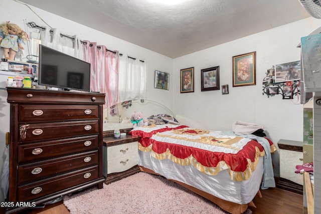 bedroom with wood finished floors