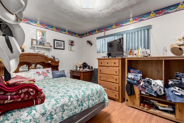 bedroom with wood finished floors