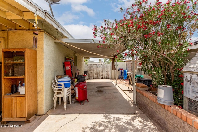 view of patio / terrace featuring fence