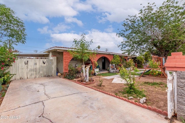 single story home with a gate, stucco siding, and concrete driveway