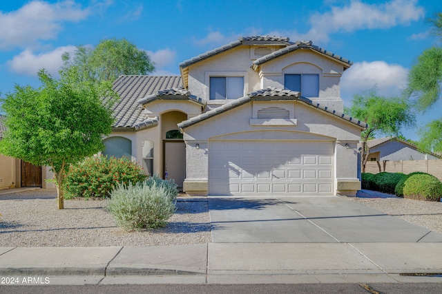 mediterranean / spanish-style home with a garage