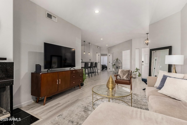 7936 E Wilshire Dr Unit 205, Scottsdale, AZ 85257 - living room with light wood-type flooring, baseboards, visible vents, and recessed lighting