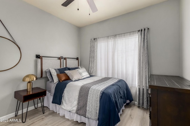 7936 E Wilshire Dr Unit 205, Scottsdale, AZ 85257 - bedroom with light wood-style flooring, ceiling fan, and baseboards