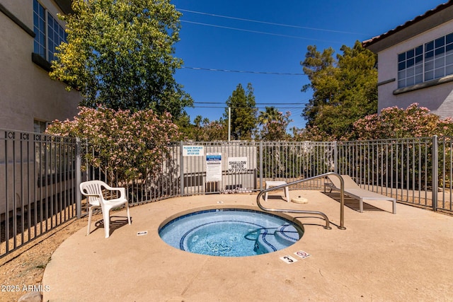 7936 E Wilshire Dr Unit 205, Scottsdale, AZ 85257 - view of swimming pool with fence and a hot tub