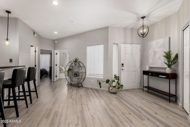7936 E Wilshire Dr Unit 205, Scottsdale, AZ 85257 - foyer with light wood-type flooring, visible vents, recessed lighting, a notable chandelier, and baseboards